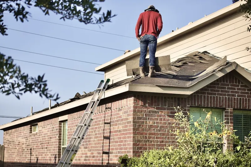 Professional roofer working on a residential roof in Indian Oaks